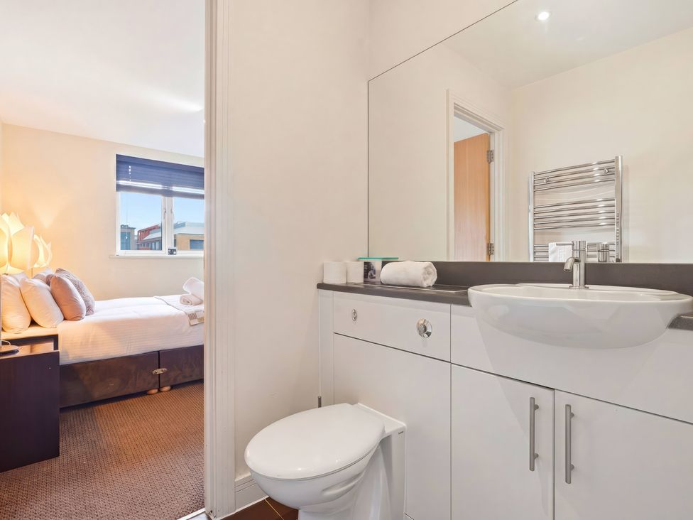 A bathroom with a toilet and sink at Apartment 28, Birmingham