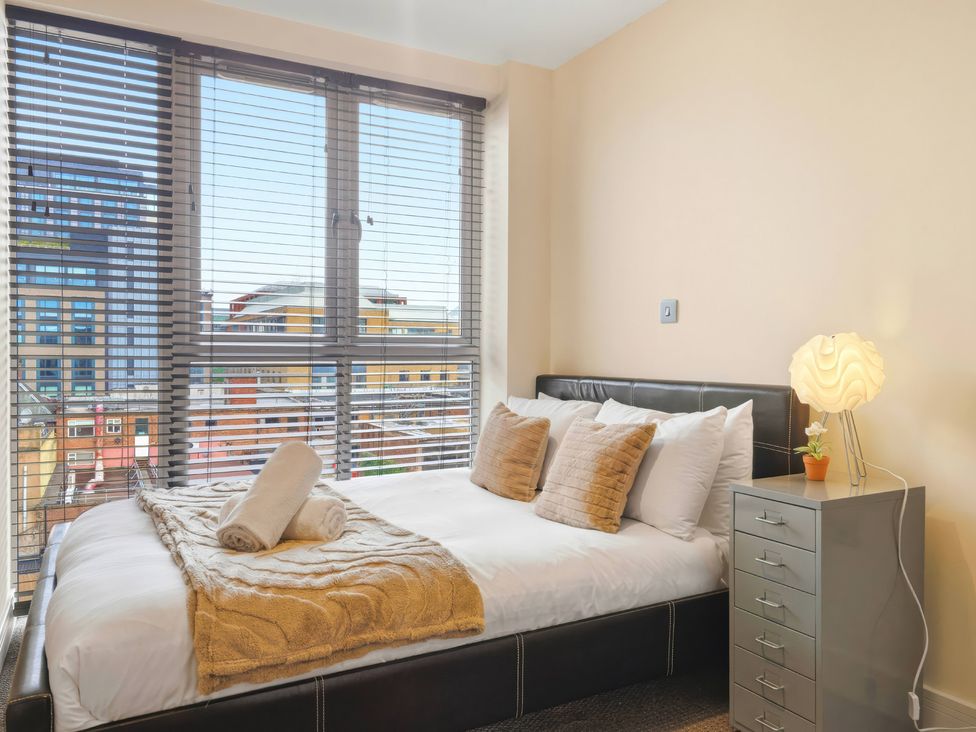 A bedroom with a bed and window at Apartment 28 in Birmingham