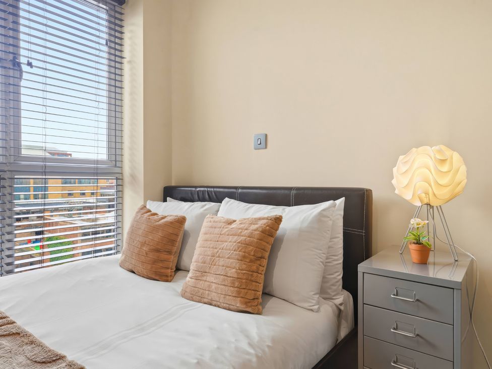 A bedroom with a bed and lamp at Apartment 28 in Birmingham