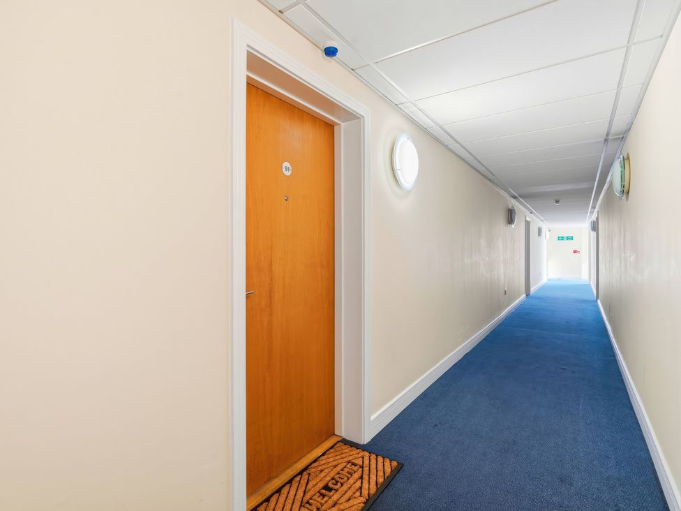 A hallway with a door and a doormat at Apartment 28 Birmingham