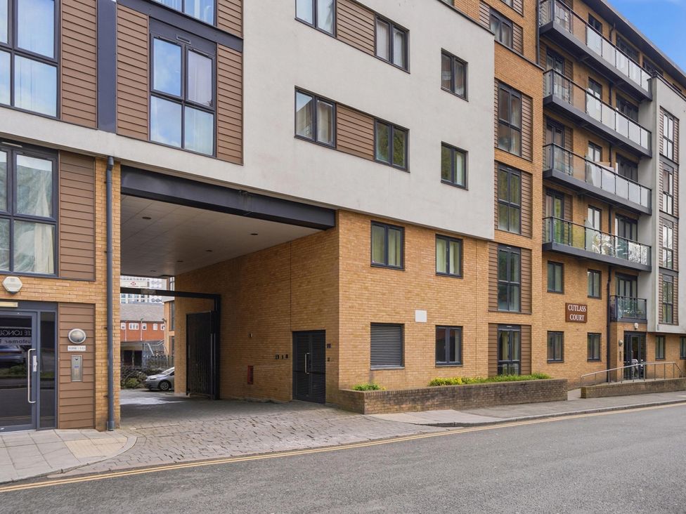 A residential building with multiple windows and entrance at Cutlass Court in Birmingham