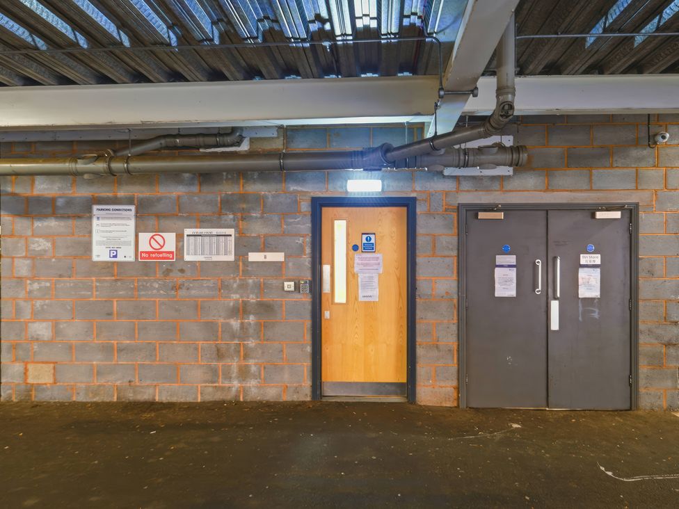 Two doors and signs on the wall in an indoor area at Apartment 28 Birmingham