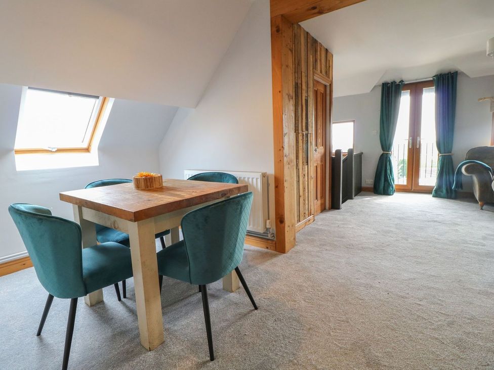 A dining area with a table and chairs at The Old Print House in Ilkeston