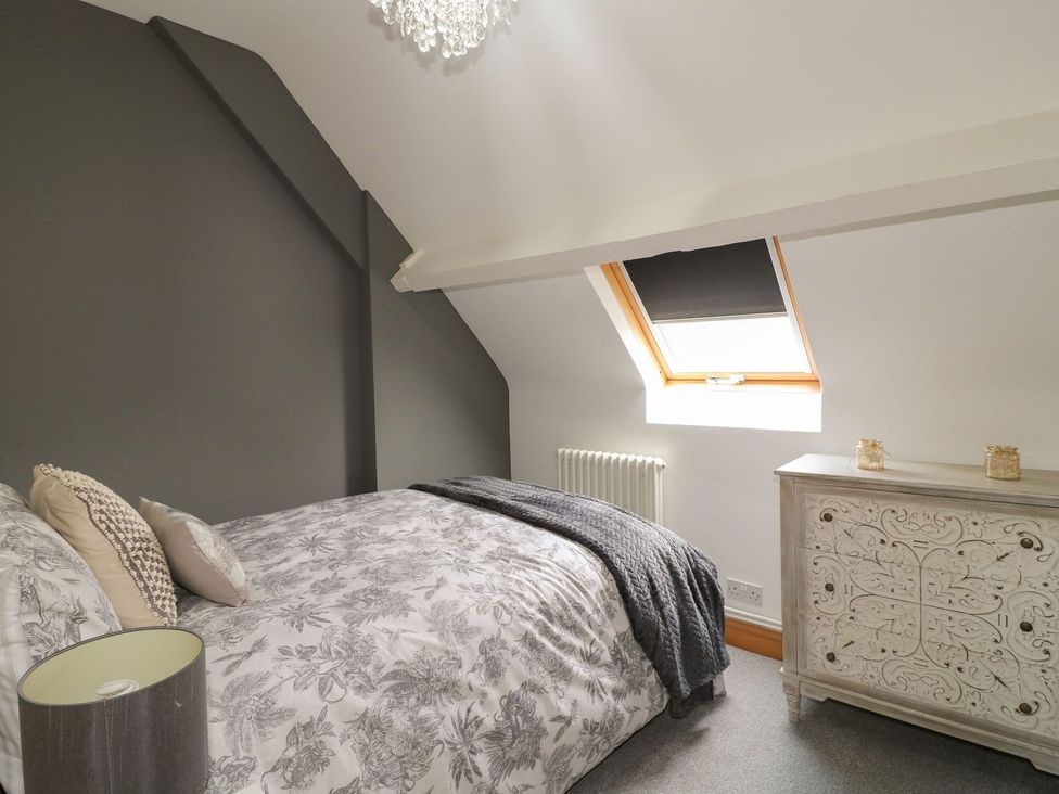 A bedroom with a bed and window at The Old Print House in Ilkeston