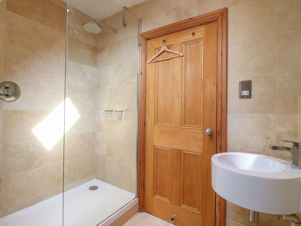 A bathroom with a shower and sink at Old Print House in Ilkeston