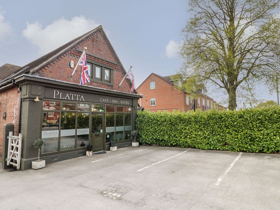 A cafe with parking area and flags at Platta in Ilkeston