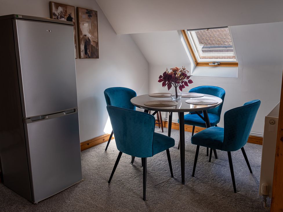 A dining room with a table and chairs at The Old Print House in Stanley Common