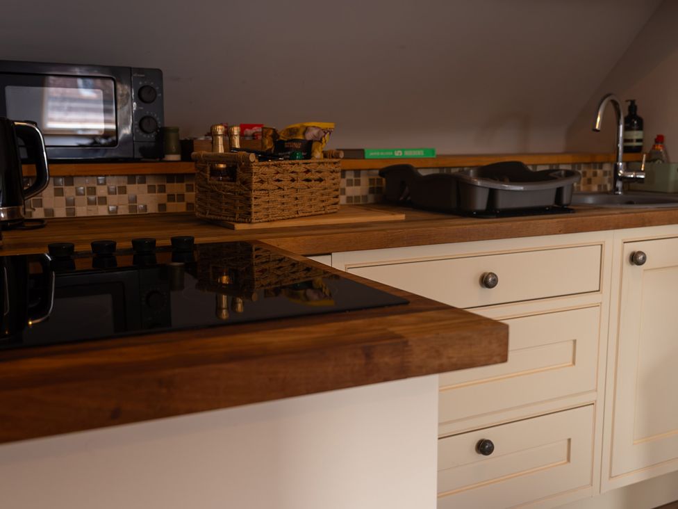A kitchen with appliances and storage at The Old Print House Stanley Common