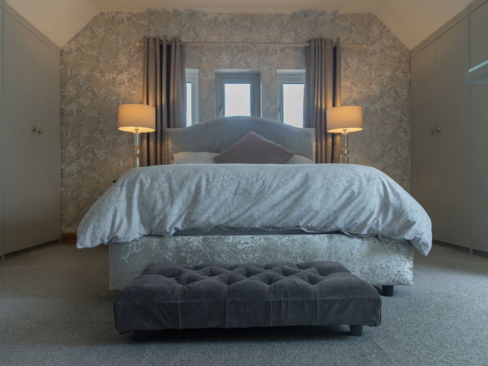 A bedroom with a bed and bedside lamps at The Old Print House in Stanley Common