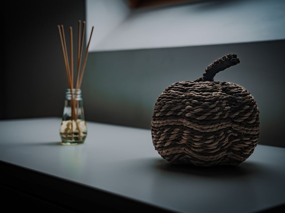 A decorative object and a glass jar with reeds at The Old Print House in Stanley Common