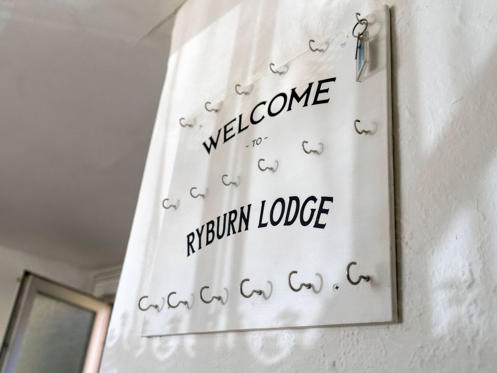 A welcome sign with coat hooks at Ryburn Lodge in Bridlington