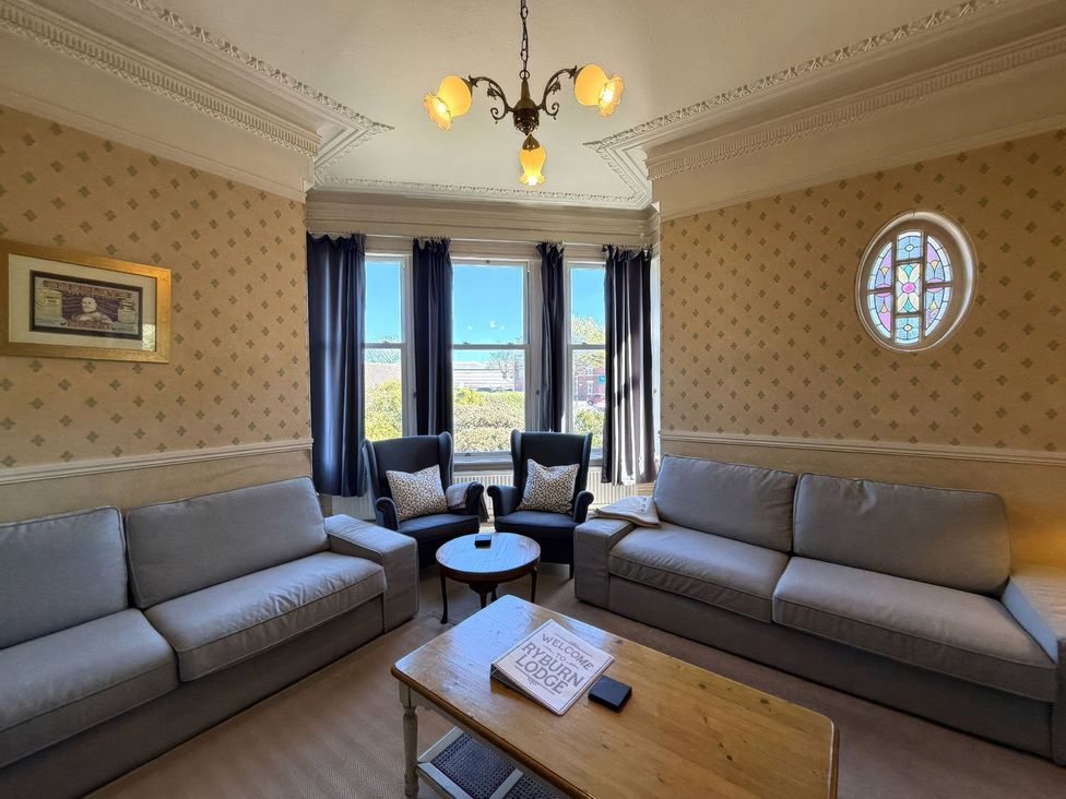 A living room with sofas and armchairs at Ryburn Lodge Bridlington