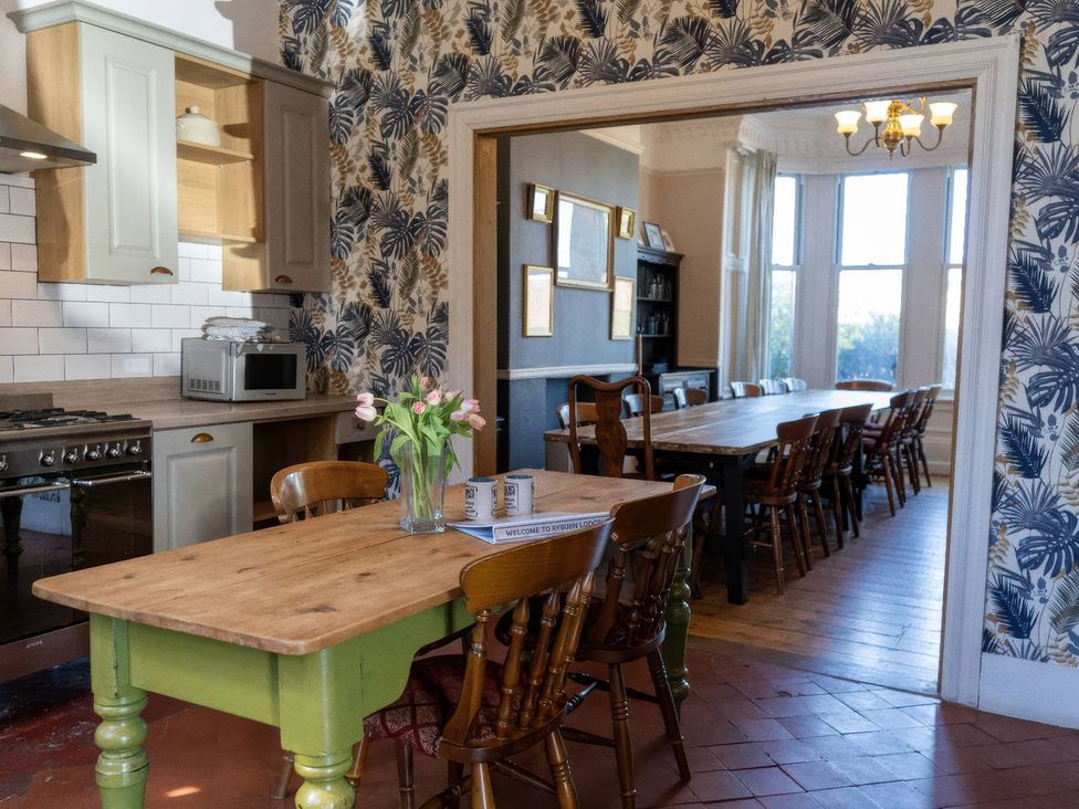 A kitchen with a table and chairs at Ryburn Lodge Bridlington