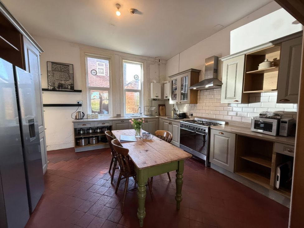A kitchen with a table and chairs at Ryburn Lodge in Bridlington