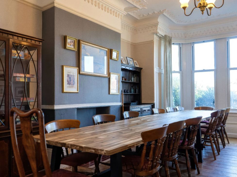 A dining room with a long table and chairs at Ryburn Lodge in Bridlington