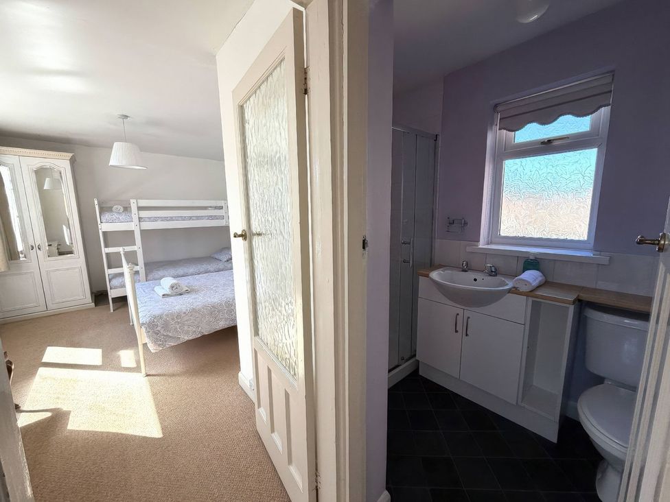 A bedroom with a bunk bed and en-suite bathroom at Ryburn Lodge in Bridlington