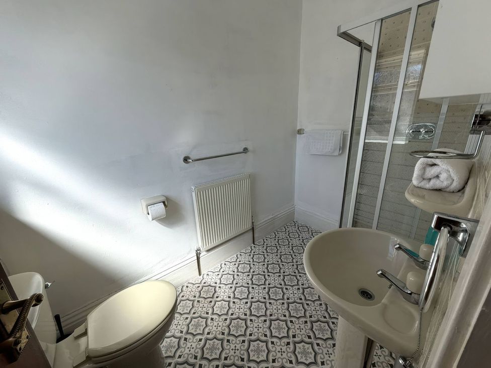 A bathroom with shower and sink at Ryburn Lodge in Bridlington