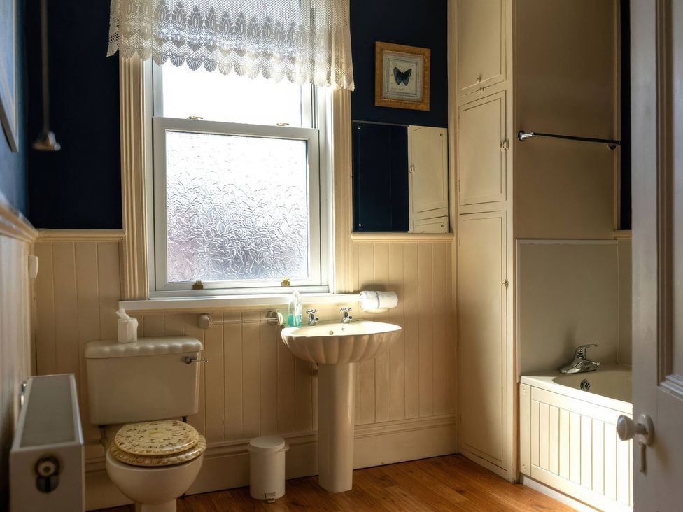 A bathroom with a toilet, sink, and bathtub at Ryburn Lodge in Bridlington