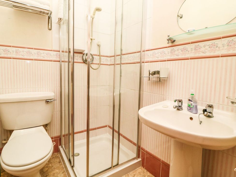 A bathroom with a shower, toilet, and sink at Ryburn Lodge in Bridlington