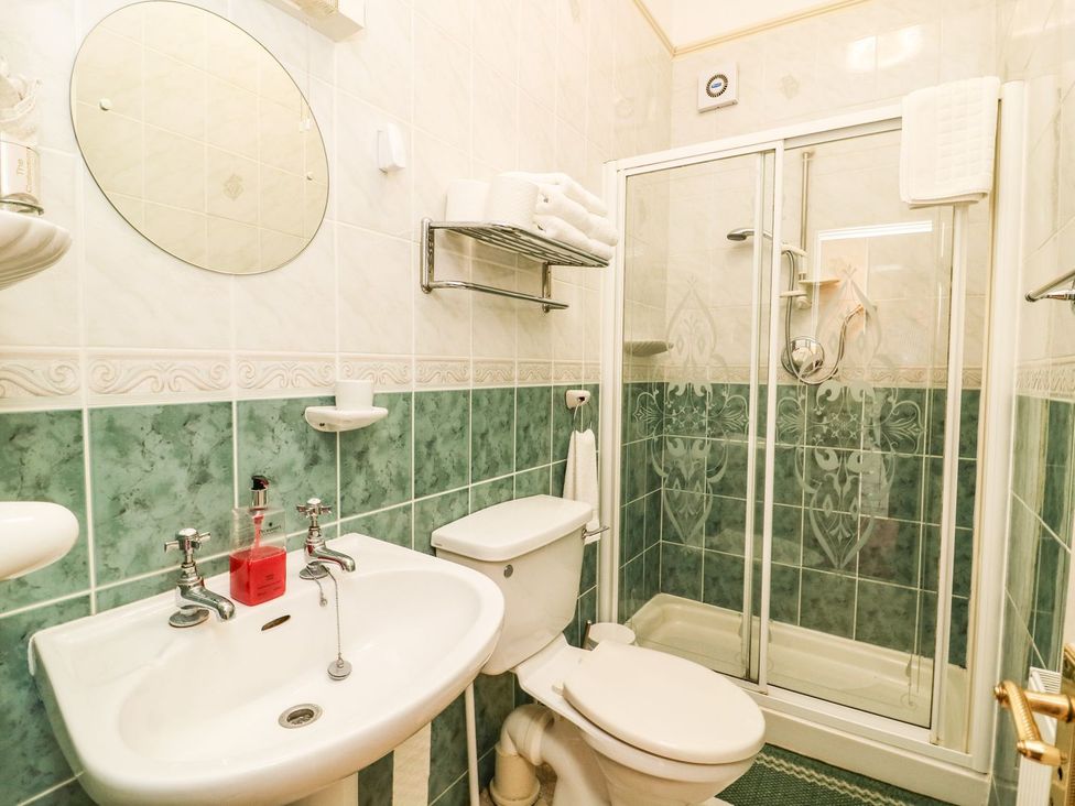 A bathroom with a sink, toilet, and shower at Ryburn Lodge in Bridlington