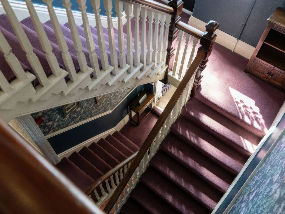 A staircase with a banister in a hallway at Ryburn Lodge Bridlington