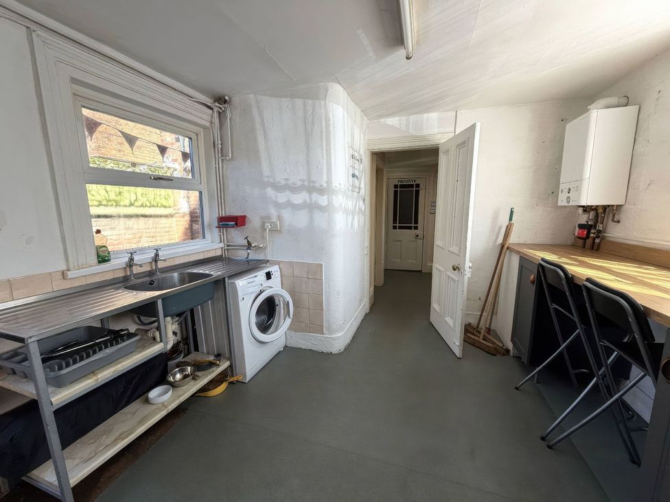 A kitchen with a sink and washing machine at Ryburn Lodge in Bridlington
