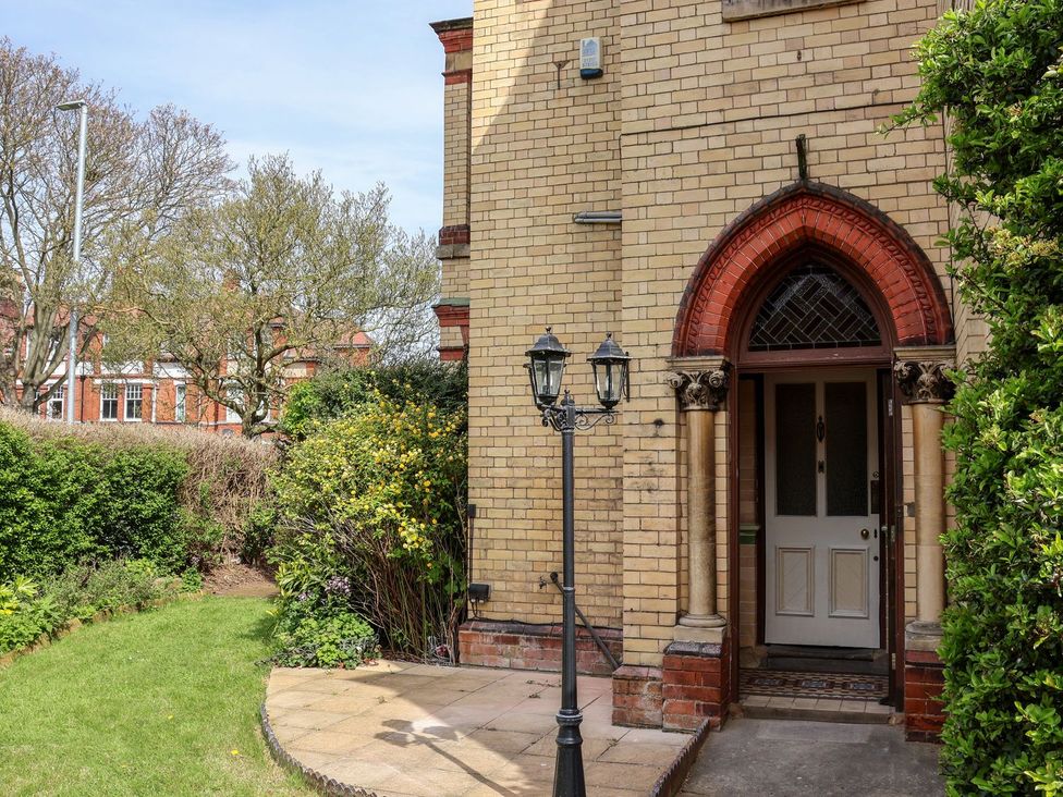 An entrance with a door and lamppost at Trinity Lodge in Bridlington