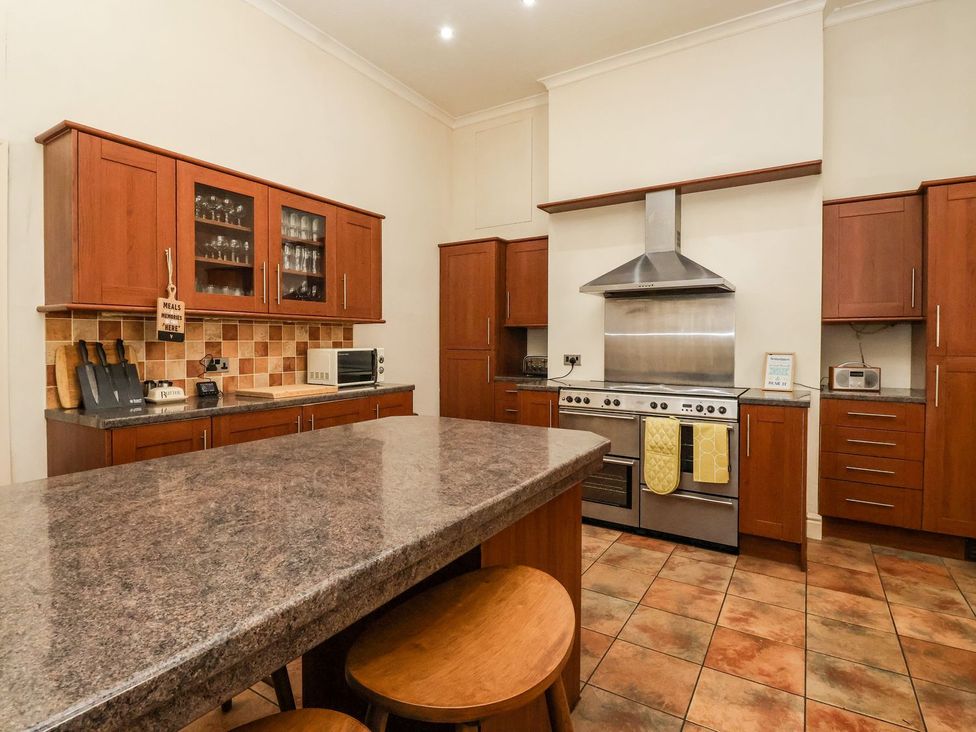 A kitchen with cabinets and stainless steel appliances at Trinity Lodge in Bridlington