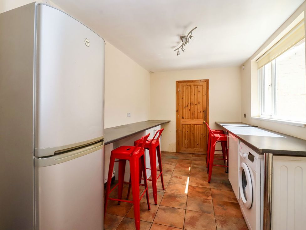 A kitchen with a refrigerator and washing machine at Trinity Lodge in Bridlington