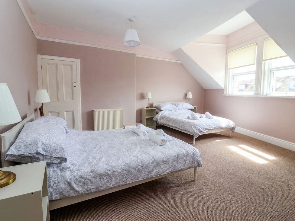 A bedroom with two beds and a window at Trinity Lodge in Bridlington