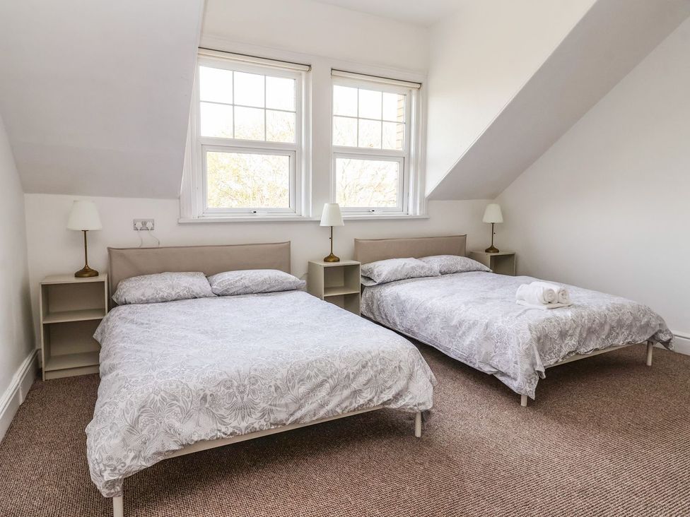 A bedroom with two beds and lamps at Trinity Lodge Bridlington