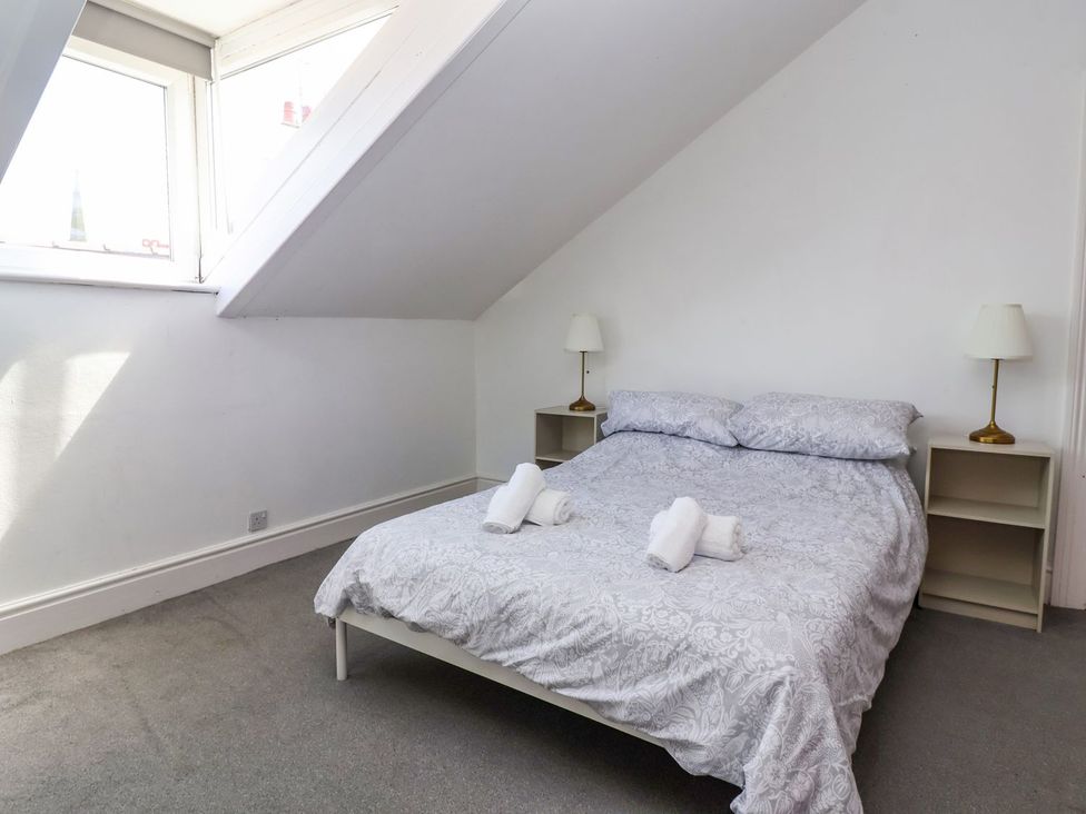 A bedroom with a bed and nightstands at Trinity Lodge in Bridlington