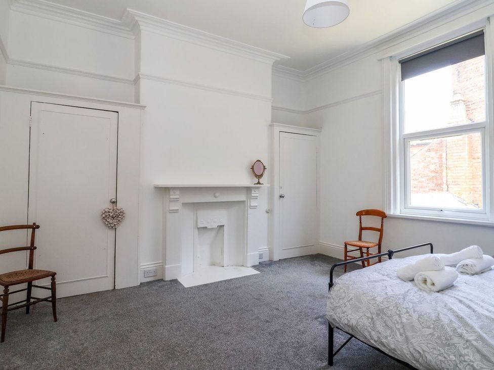 A bedroom with a bed and a fireplace at Trinity Lodge in Bridlington