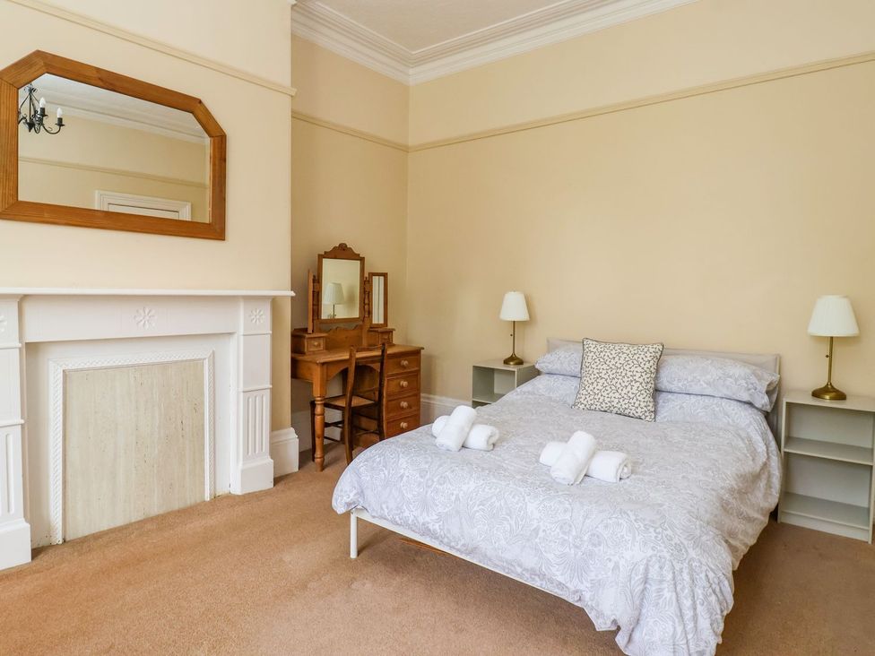 A bedroom with a bed and dresser at Trinity Lodge in Bridlington