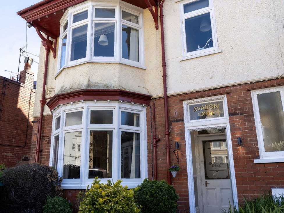 An exterior view of a house with a sign at Avalon Lodge in Bridlington