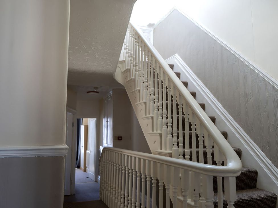 A staircase in a hallway at Avalon Lodge in Bridlington