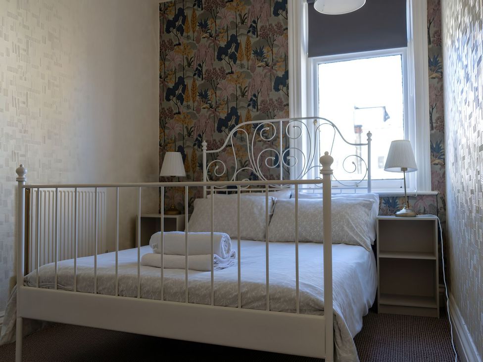 A bedroom with a bed and bedside table at Avalon Lodge in Bridlington