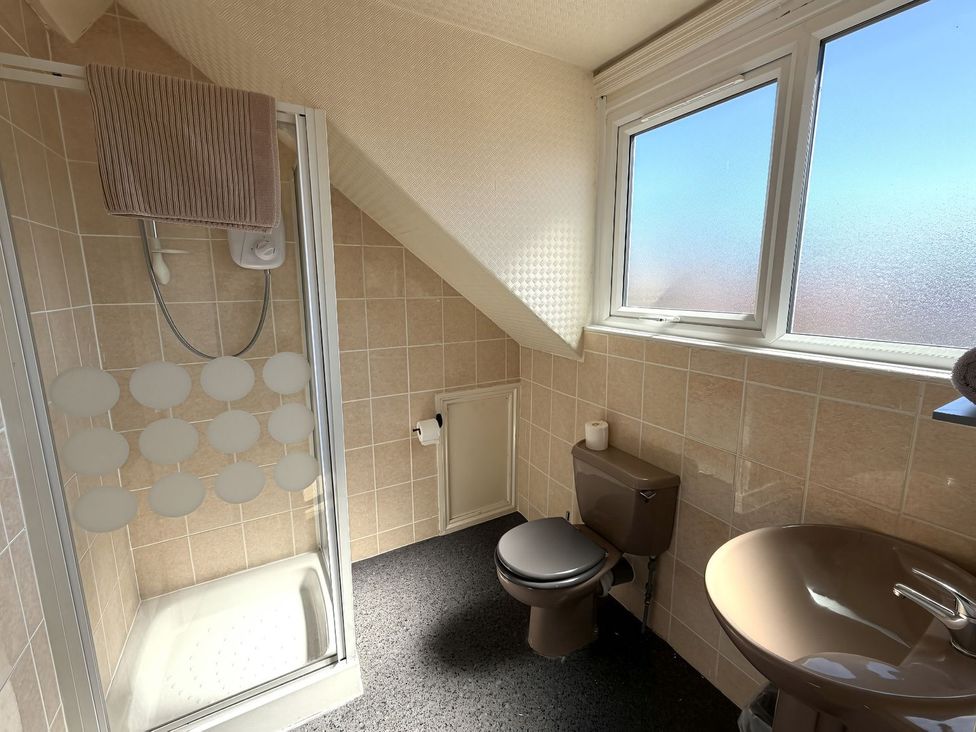 A bathroom with a shower, toilet, and sink at Avalon Lodge in Bridlington