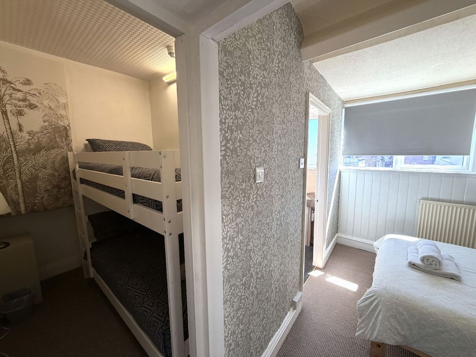 A bedroom with a bunk bed and a single bed at Avalon Lodge in Bridlington