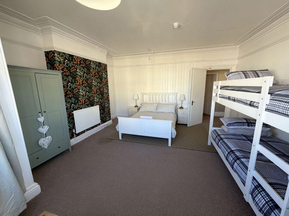 A bedroom with a bed and a bunk bed at Avalon Lodge in Bridlington