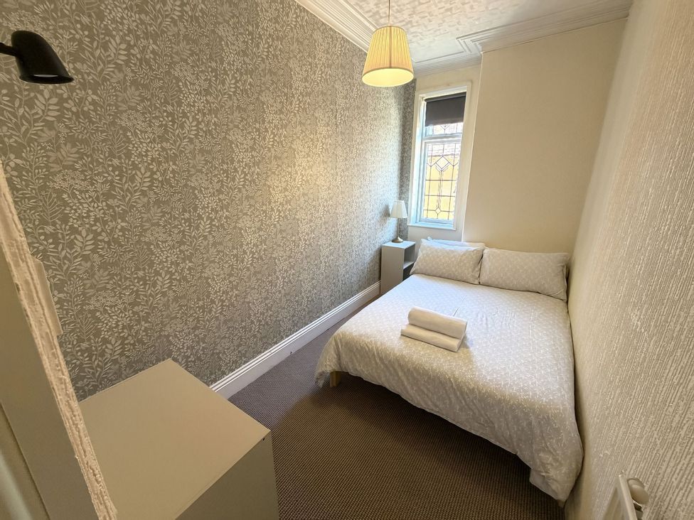 A bedroom with a bed and lamp at Avalon Lodge in Bridlington