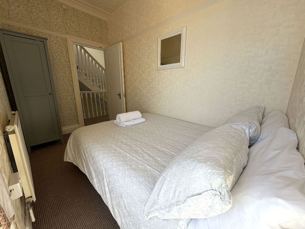 A bedroom with a bed and wardrobe at Avalon Lodge in Bridlington