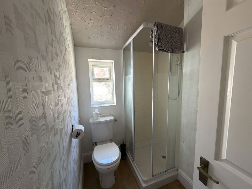 A bathroom with a toilet and shower at Avalon Lodge in Bridlington