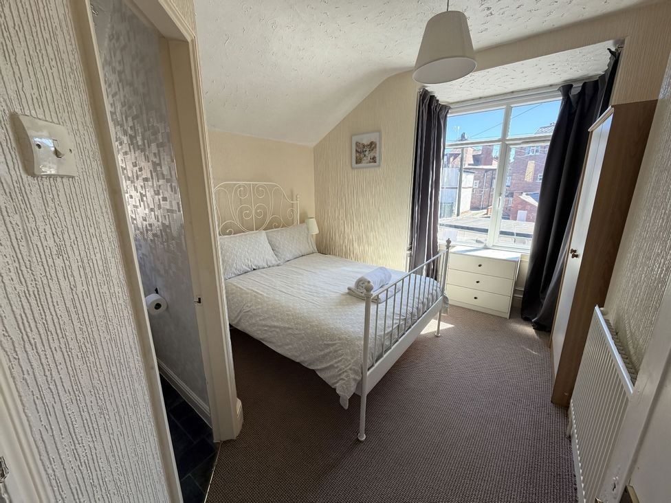 A bedroom with a bed and drawers at Avalon Lodge in Bridlington