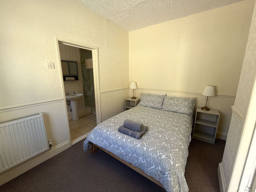 A bedroom with a bed and nightstand at Avalon Lodge in Bridlington