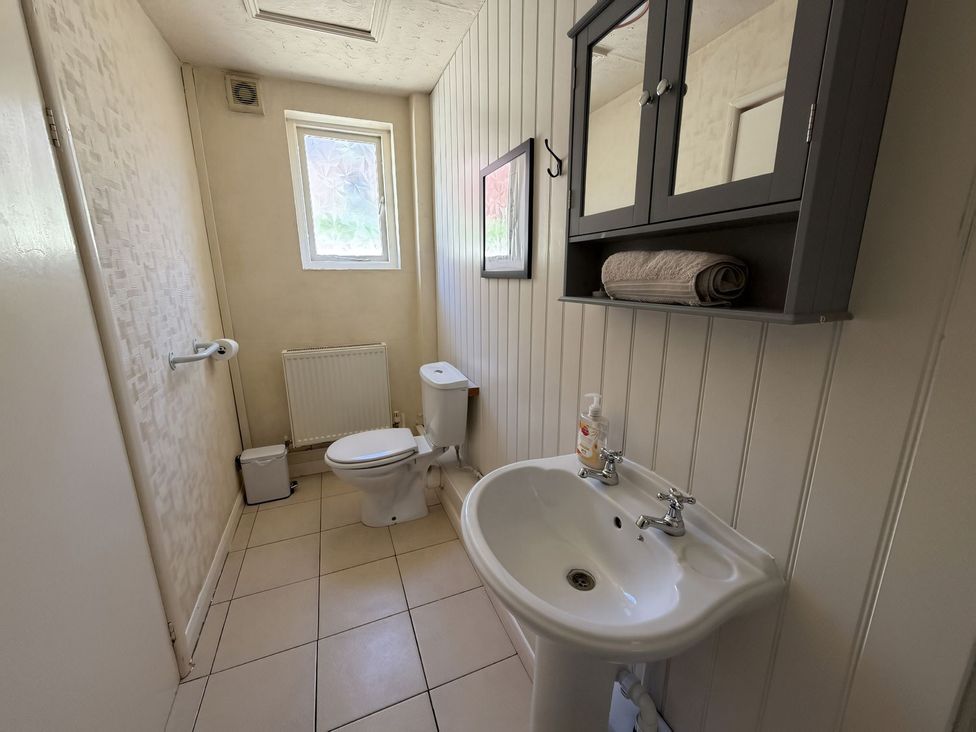 A bathroom with a toilet and sink at Avalon Lodge in Bridlington