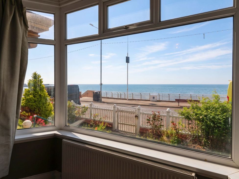 A view of the ocean and street from a living room window at Sunrise Lodge in Bridlington