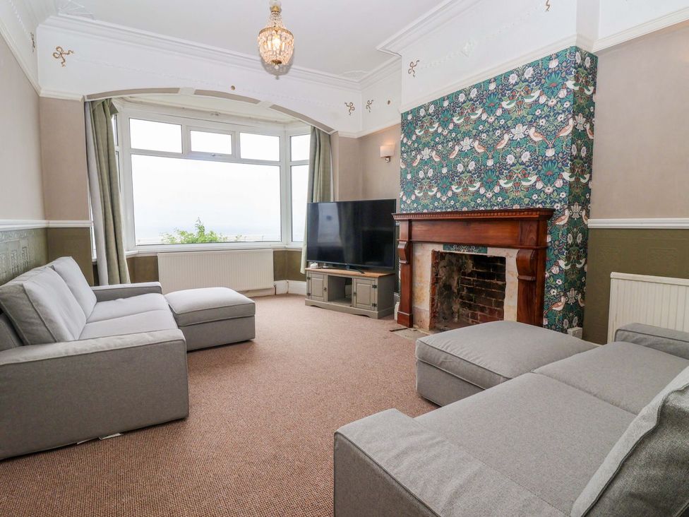 A living room with a television and sofa at Sunrise Lodge in Bridlington