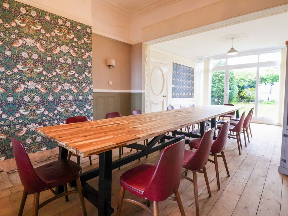 A dining room with a large table and chairs at Sunrise Lodge in Bridlington