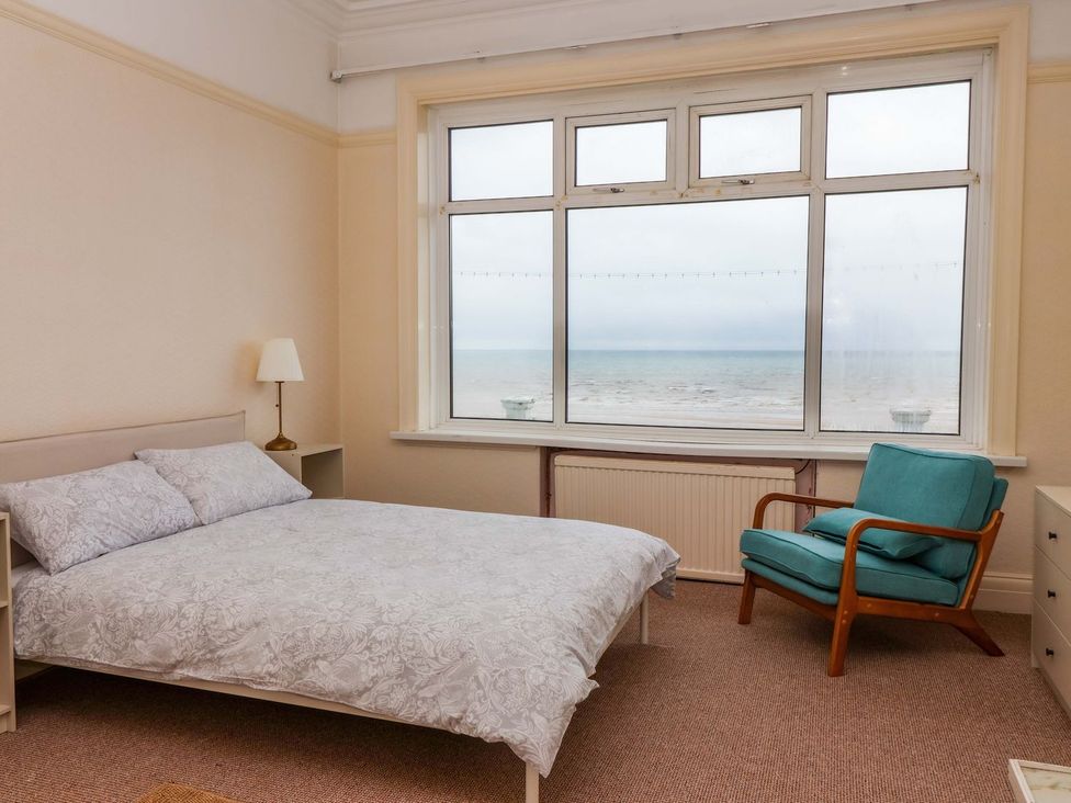 A bedroom with a bed and chair at Sunrise Lodge in Bridlington